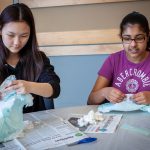 Angelina Lee, left, and Sristhi Chowdhury from Timothy Edwards Middle School in South Windsor, Connecticut use diapers to observe cross-linking of polymers. (Christopher LaRosa/UConn Photo)