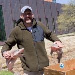 Doug Feeney, a fisherman representing Red’s Best, poses with two dogfish – fish that are commonly served in the dining halls on campus. Red’s Best is a locally owned fishery that partners with UConn for sustainable seafood. (Lucas Voghell ’20 (CLAS)/UConn Photo)
