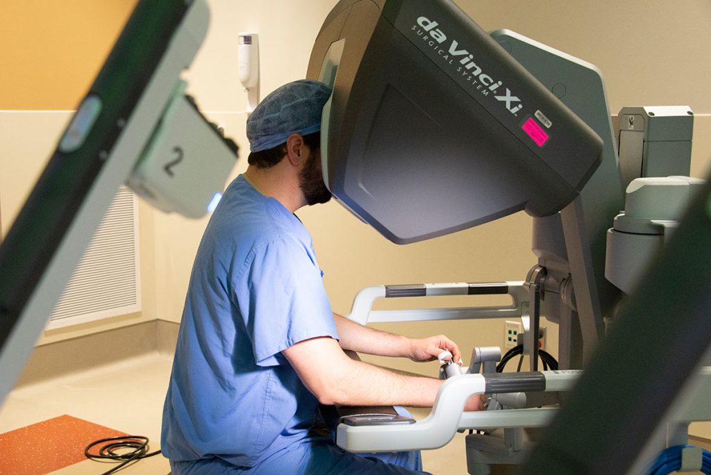 Dr. Eric Girard, a surgeon who specializes in colorectal surgery, with da Vinci Xi Robotic Surgery System. (Kristin Wallace/UConn Health Photo)