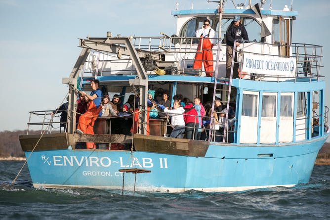 Project Oceanology class retrieves a bottom trawl at the mouth of the Thames River. (Anna Sawin/UConn Photo)