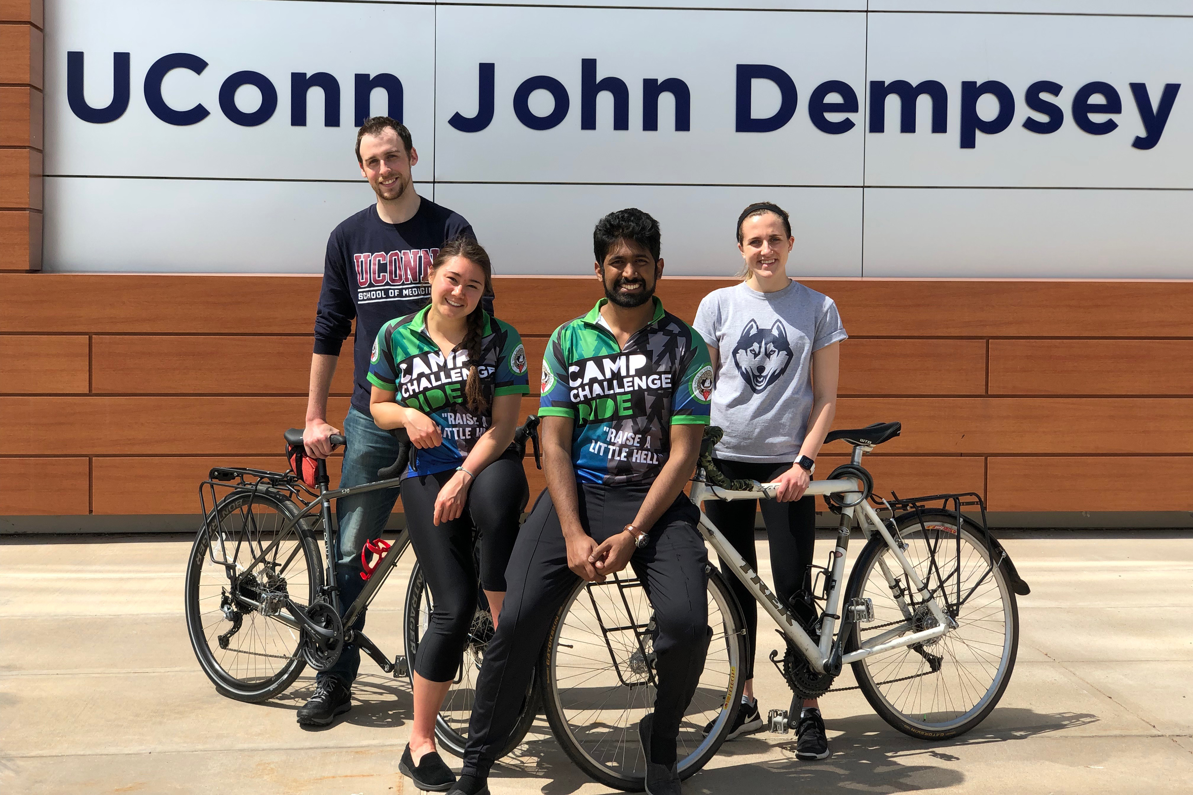 Justin Hoffman, Keanna Chang, Yoga Kammili, and Liz Rodier with two bikes in front of UConn John Dempsey Hospital