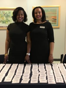 Dominique Battle-Lawson ’07 (ED), ’08 MA and Mia Hines, academic advisors in the Neag School, greet guests at the Spring 2019 Education Career Fair. (Shawn Kornegay/Neag School)