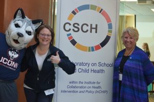 Jonathan the Husky celebrates UConn’s 2019 Giving Day with Board of Trustees Distinguished Professor Sandra Chafouleas and Professor E. Carol Polifroni (right), co-directors of the Collaboratory on School and Child Health, at the Gentry Building in March. (Shawn Kornegay/Neag School)