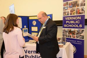Joseph Macary ’94 (ED), ’08 ELP, ’16 Ed.D, superintendent of Vernon (Conn.) Public Schools, speaks with a student during the Neag School’s Spring 2019 Education Career Fair. (Shawn Kornegay/Neag School)