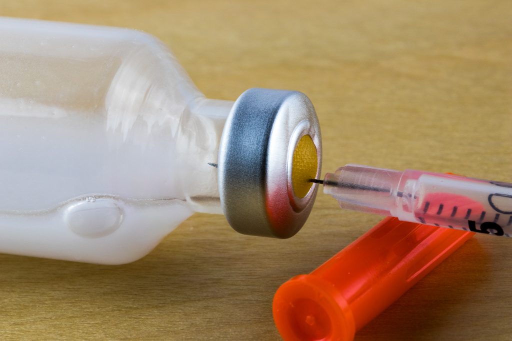 Close-up of insulin bottle on table. (Getty Images)