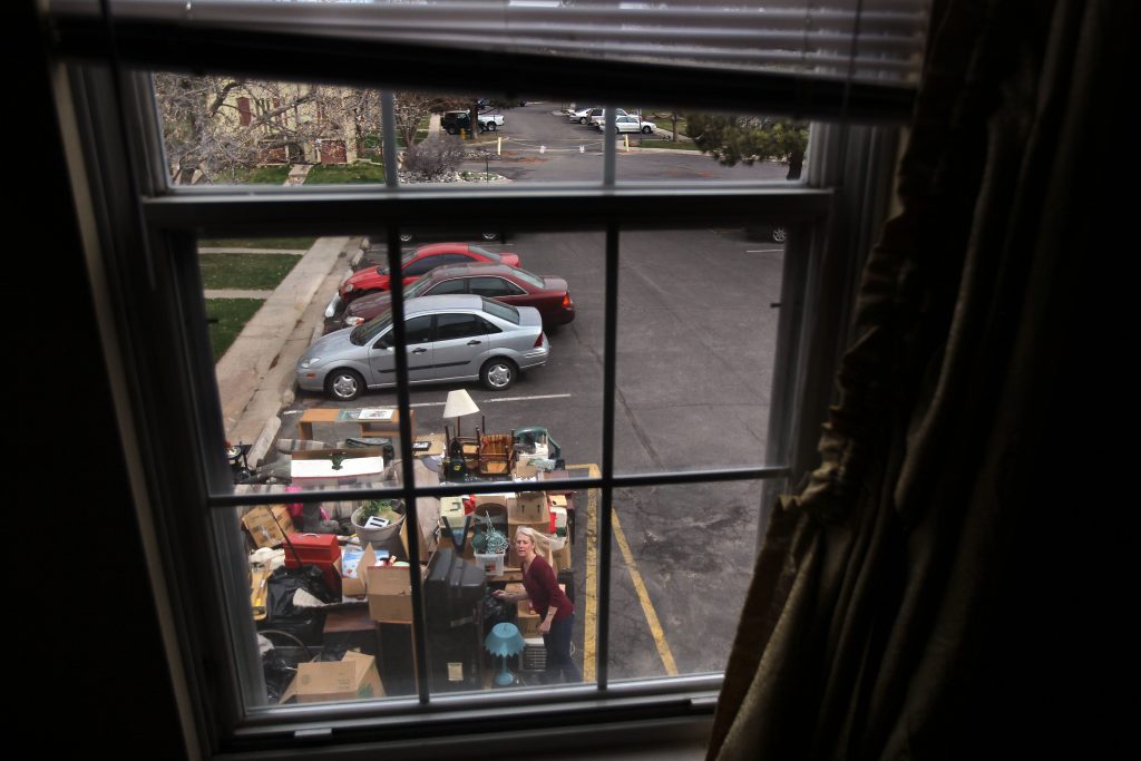 An eviction team removes belongings from a family's rented apartment after tenants failed to pay rent for almost three months. (John Moore/Getty Images)