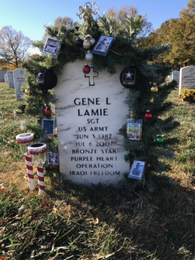 The grave of an American soldier who served in the Iraq war, decorated with mementos, in Section 60 of the Arlington National Cemetery. (Photo courtesy of Christine Sylvester)