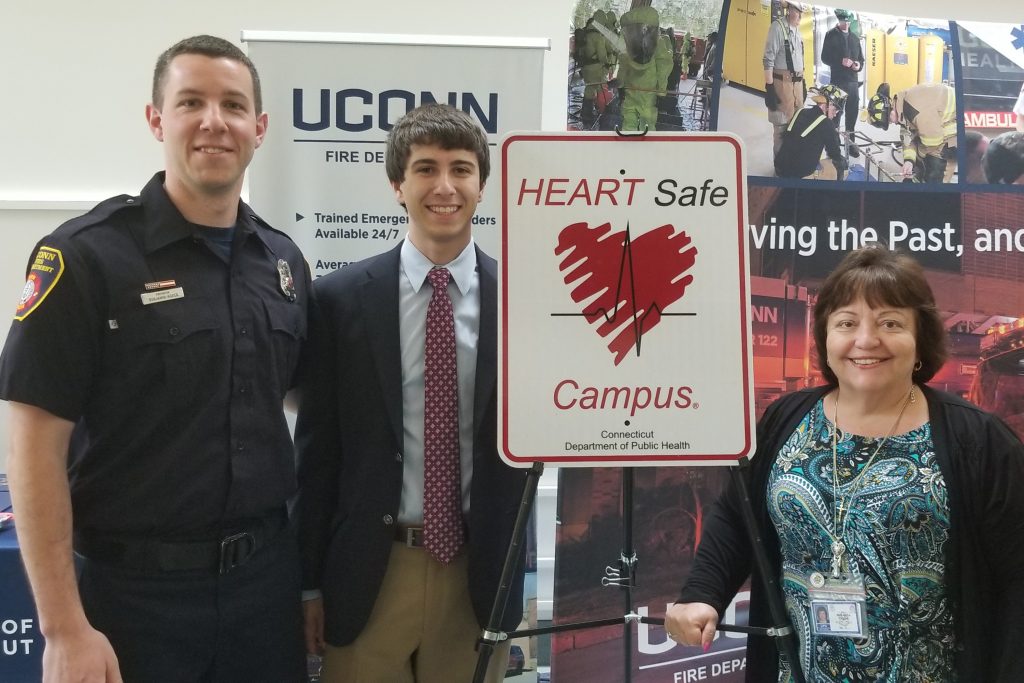 From left, UConn firefighter Benjamin Roper, UConn senior Justin Pedneault ’19 (NUR), and Raffaella Coler, director of the state Office of Emergency Medical Services. (Mike Enright/UConn Photo)