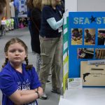 Josalynn Barber, 8, demonstrates her 'Sea Straw,' which is designed to make sea water drinkable. (Lucas Voghell ’20 (CLAS)/UConn Photo)