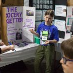 Mackenzie Smith, 9, shows how her invention 'The Grocery Getter' can assist elderly folk with their grocery shopping. (Lucas Voghell ’20 (CLAS)/UConn Photo)