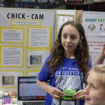 Asha Hormuzdiar, 10, takes questions about her invention to monitor the growth of baby chicks via the use of AI technology. (Lucas Voghell ’20 (CLAS)/UConn Photo)
