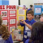 Alexander DeLuca, 10, displays how his invention 'Ez Pour' can aid disabled and elderly people in pouring their cereal in the morning. (Lucas Voghell ’20 (CLAS)/UConn Photo)