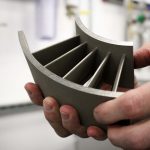 Hebert holds additively manufactured samples for R&D that emulate real-world component designs. (Carson Stifel/UConn Photo)