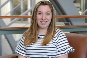 Kaitlyn Ferrara sitting in a chair in the Gentry Building.