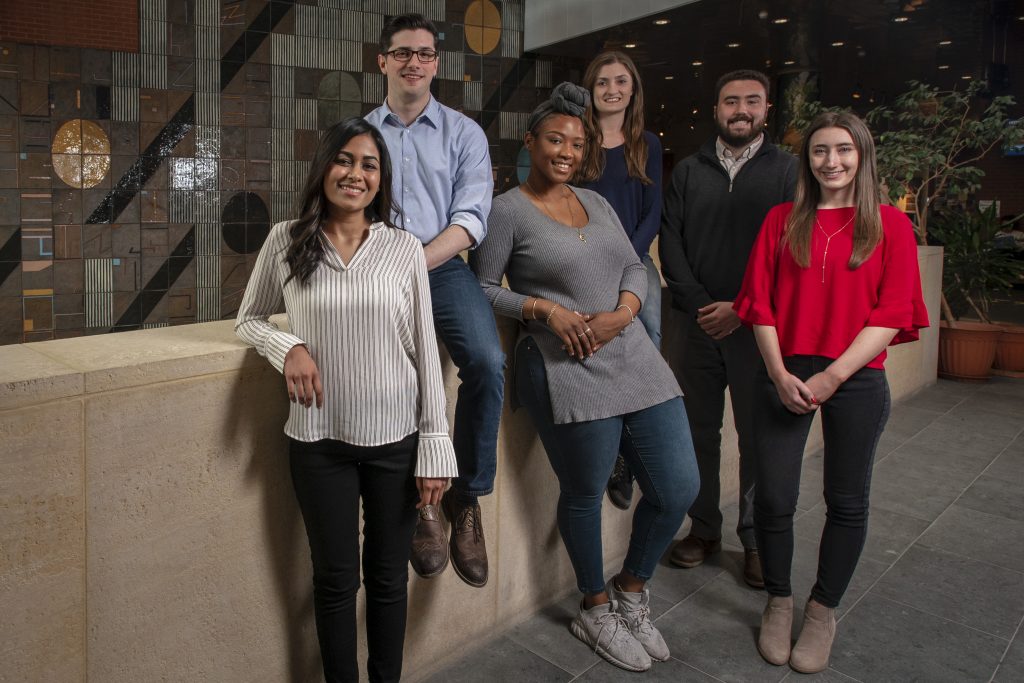 Six of this year's 11 UConn recipients of National Science Foundation graduate research fellowships at the Biology/Physics Building. From left, Hetal Patel, Eric Lepowsky, Leann McLaren, Angela Lanning, Connor Ligeikis, and Shaylin Cetegen. (Sean Flynn/UConn Photo)