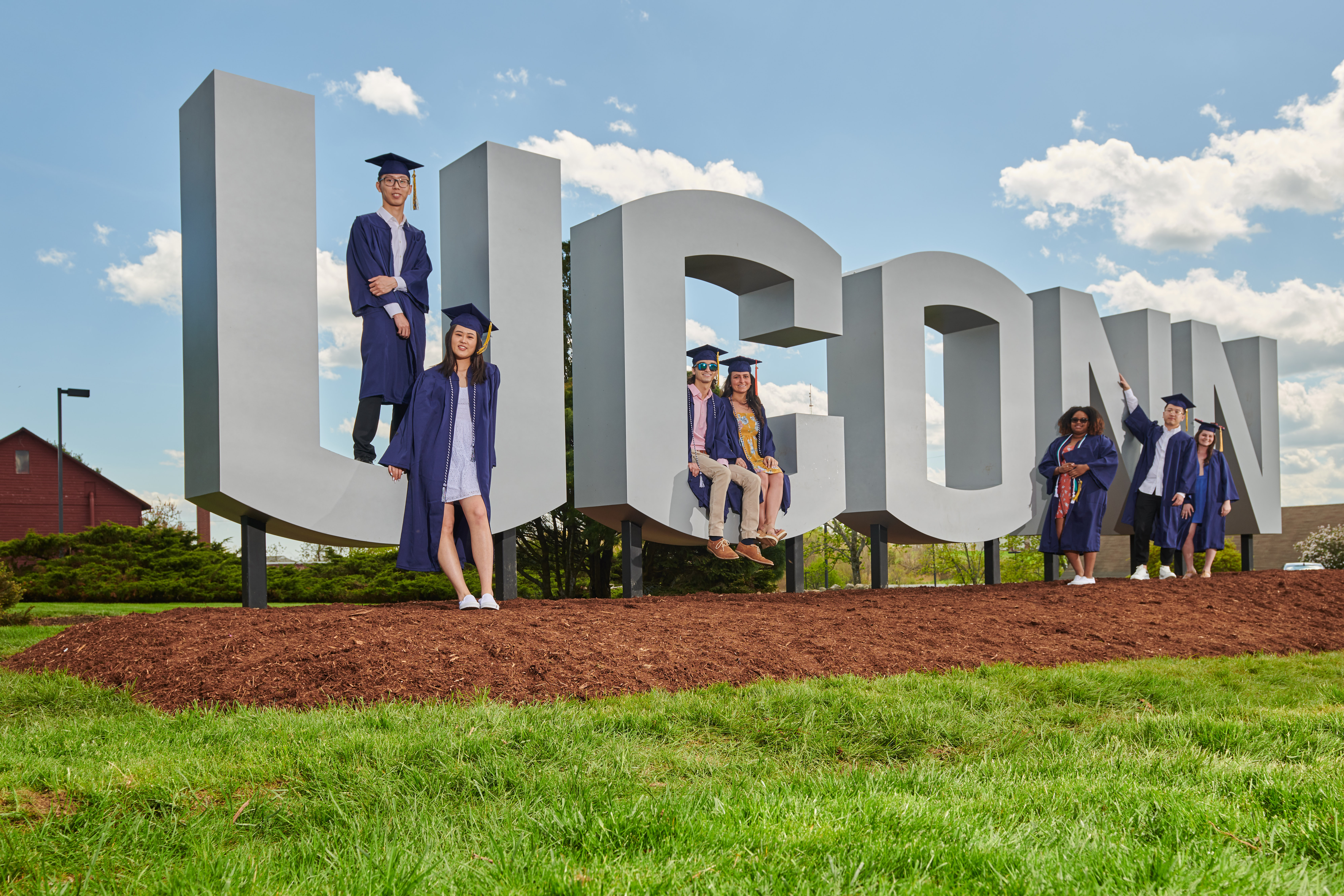 Soon to be graduates pose with the new UConn sign along Route 195. From left are Kailin Lu '19 (CLAS), Kai Lu '19 (CLAS), Harun Malik '19 (CLAS), Carley Corbo '19 (ENG), Sidayah Dawson '19 (CLAS), Zhenhao Zhang '19 (CLAS), and Debra Peel '19 (CAHNR). (Peter Morenus/UConn Photo)