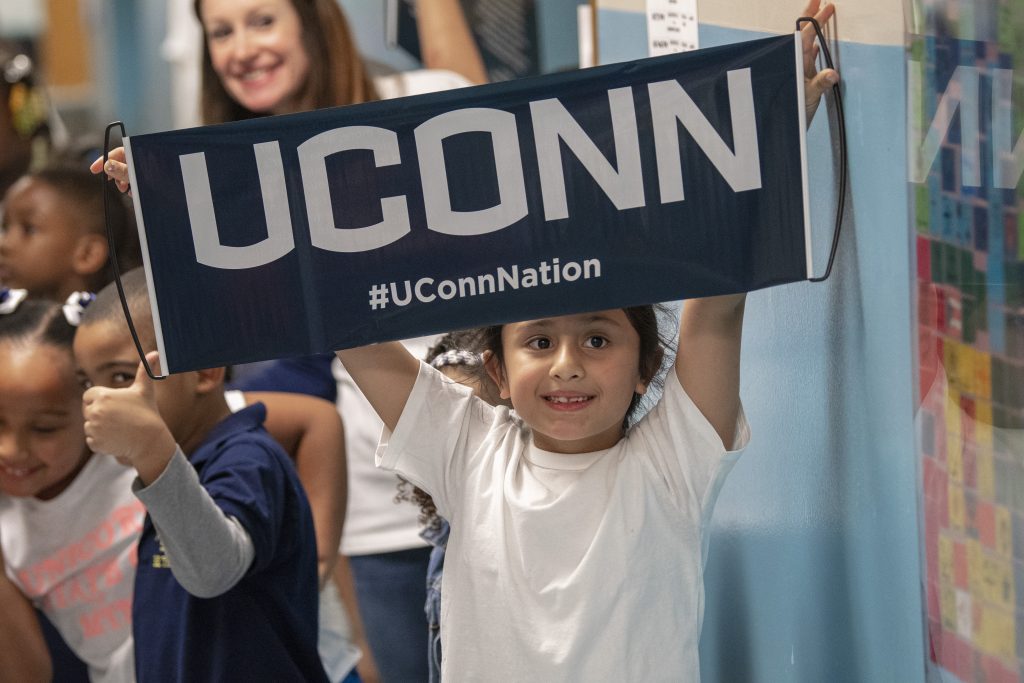 Children cheer for UConn during a parade through the halls of Kennelly School in Hartford on May 2, 2019. (Sean Flynn/UConn Photo)