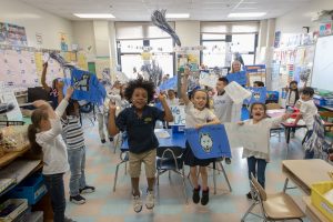Kennelly School students cheer UConn pride in a classroom on May 2, 2019. (Sean Flynn/UConn Photo)