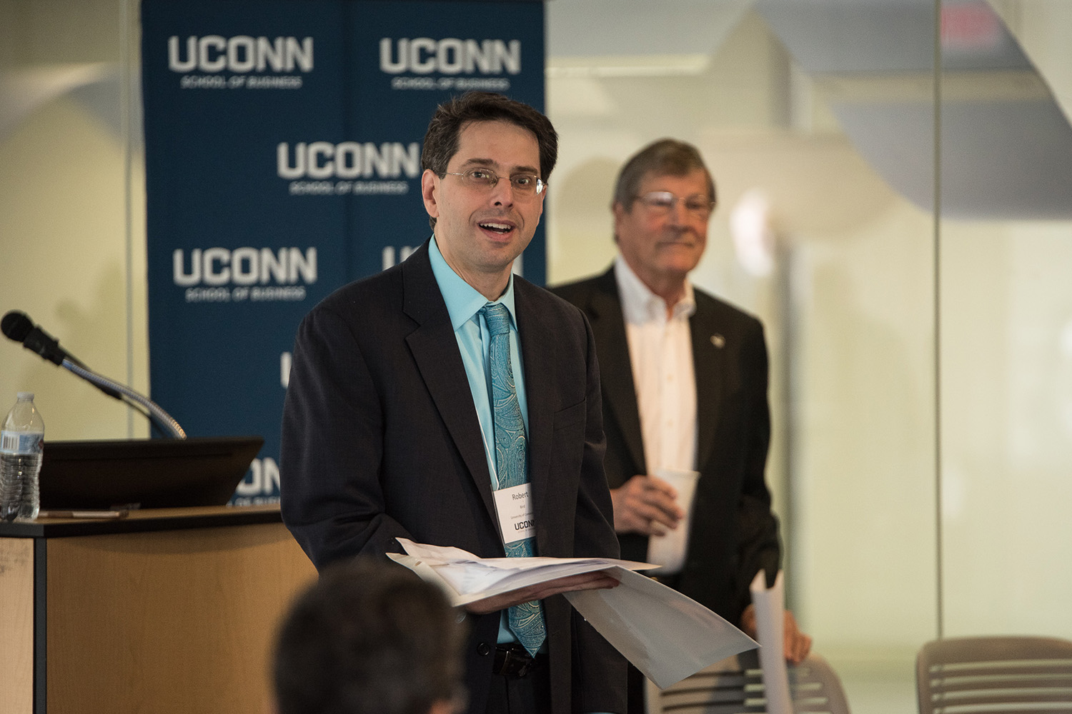 Professor Robert Bird (left) speaks during the Summit on the Academic Profession of Business Law, with Interim Provost John Elliott (Right) behind him.