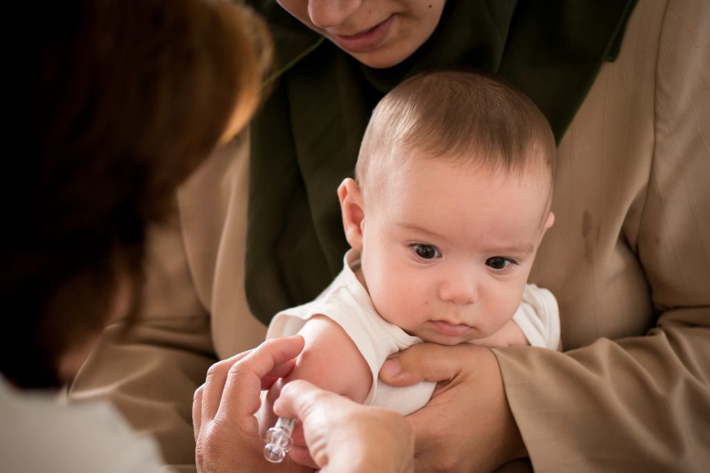 A doctor giving a baby an injection. (Getty Images)