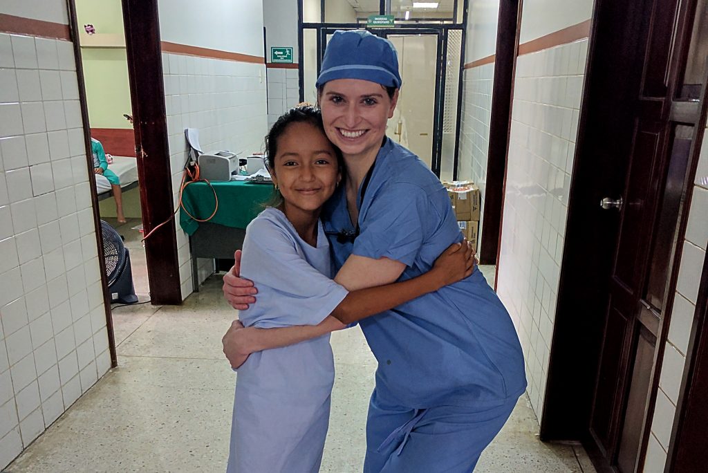 Dr. Jillian Fortier, plastic and reconstructive surgeon at UConn Health, with a young patient she helped during a mission trip abroad. (Ethan Giorgetti/UConn Health Photo)