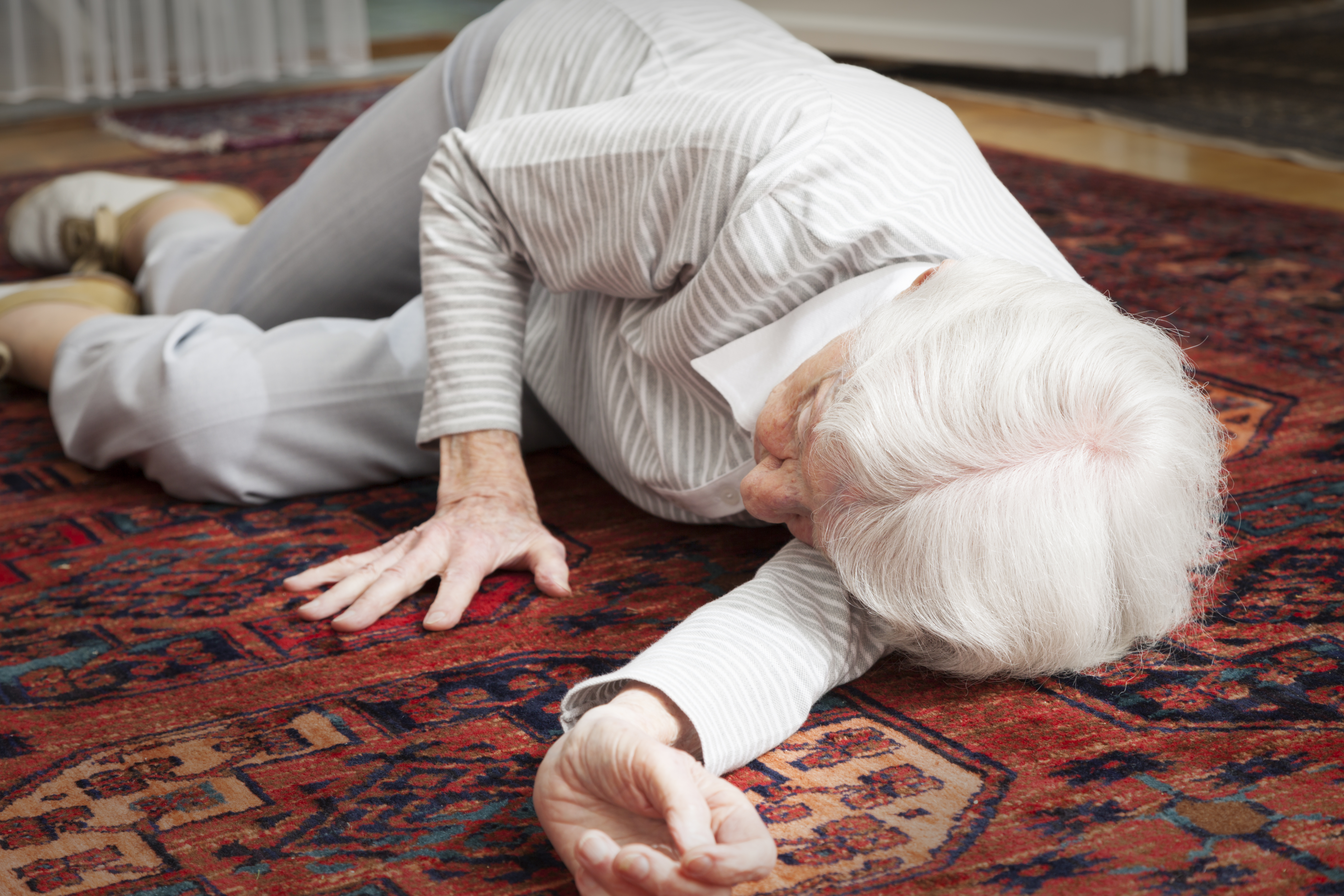 An elderly woman lying on the floor after a fall. (Getty Images)