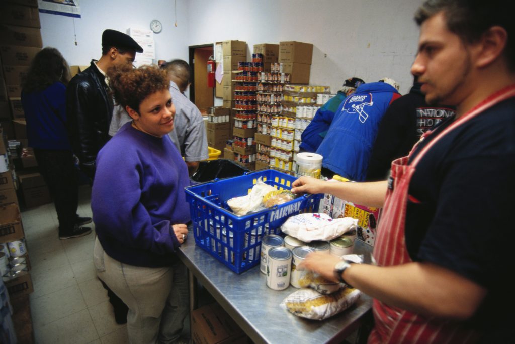 A woman receiving food from a food pantry in New York City. (Viviane Moos/Corbis via Getty Images)