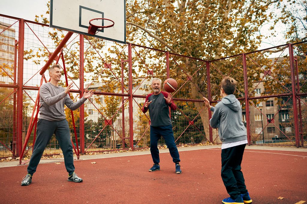 Boy, right, playing basketball with his father and grandfather. (Getty Images)