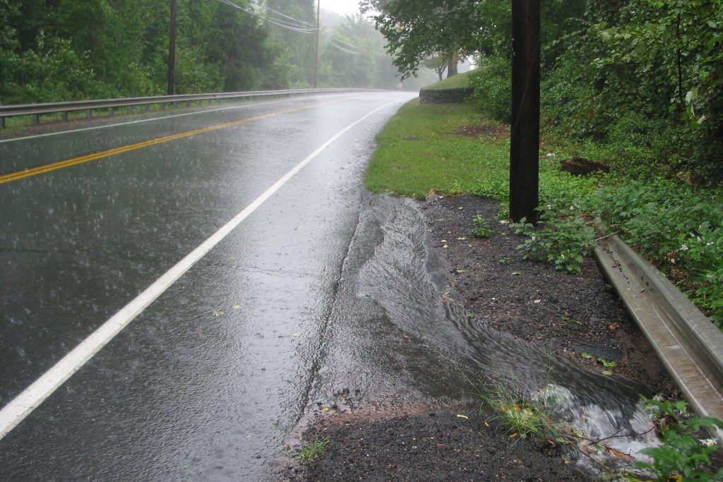 Rain overwhelms a local drainage system. (Kara Bonsack /UConn Photo)