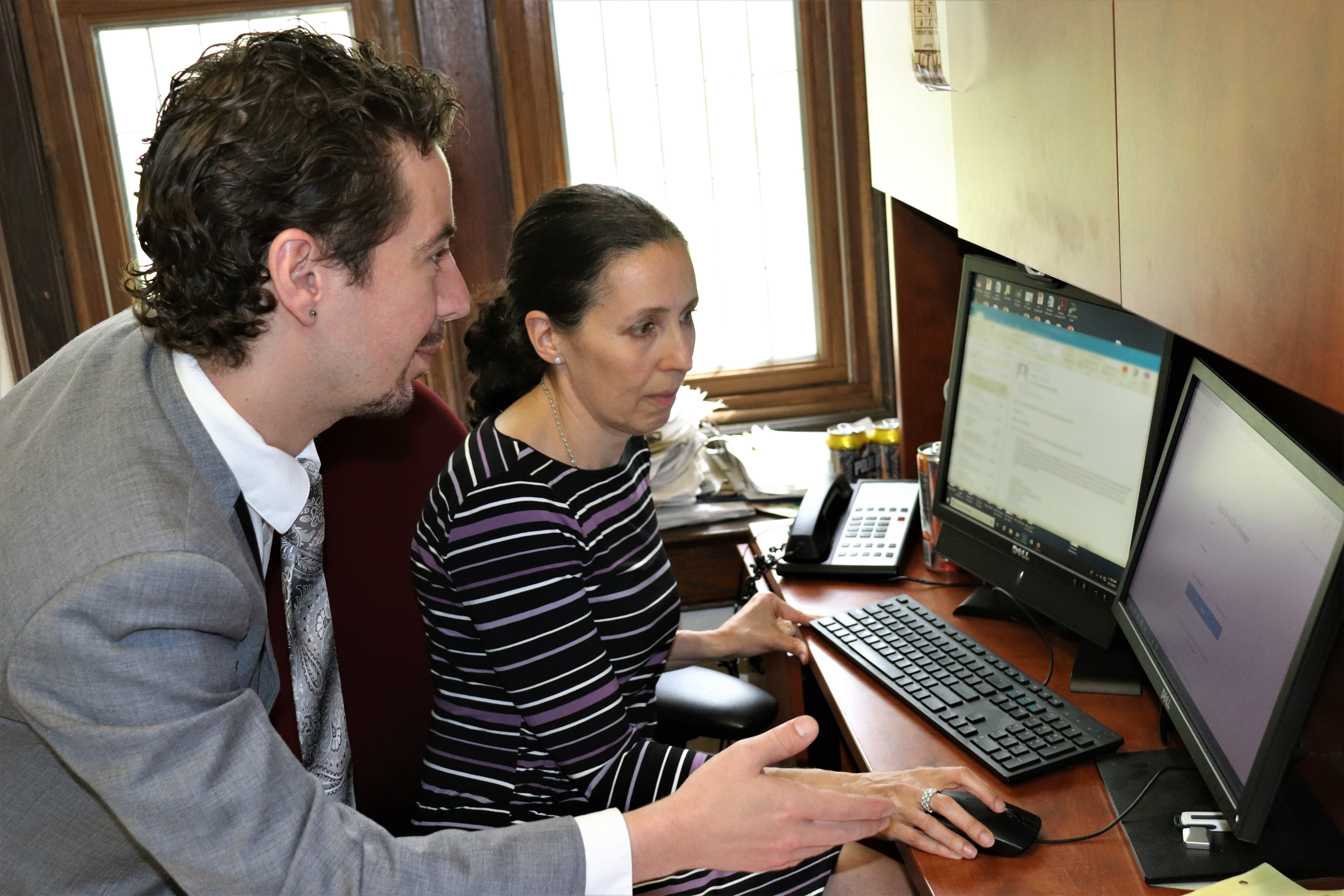 Jonathan Donovan '20 JD assists Jessica Rubin, director of the Animal Law Clinic, in using the new case management system that he and fellow students in a new Technology and Law Practice class devised for the clinic. (Camille Chill/UConn Photo)