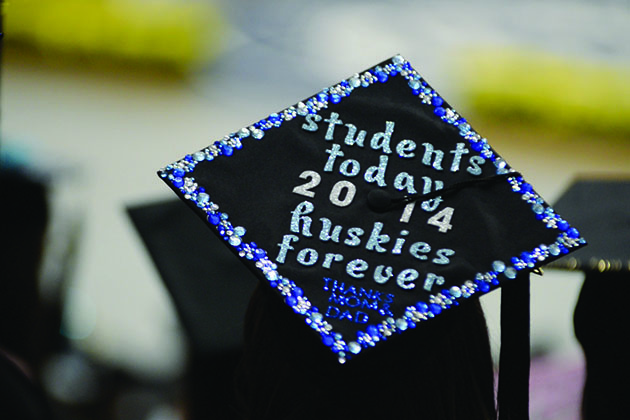 A student graduating in 2014 wears a cap with the legend, 'Students Today, Huskies Forever.' (Elizabeth Caron/UConn File Photo)