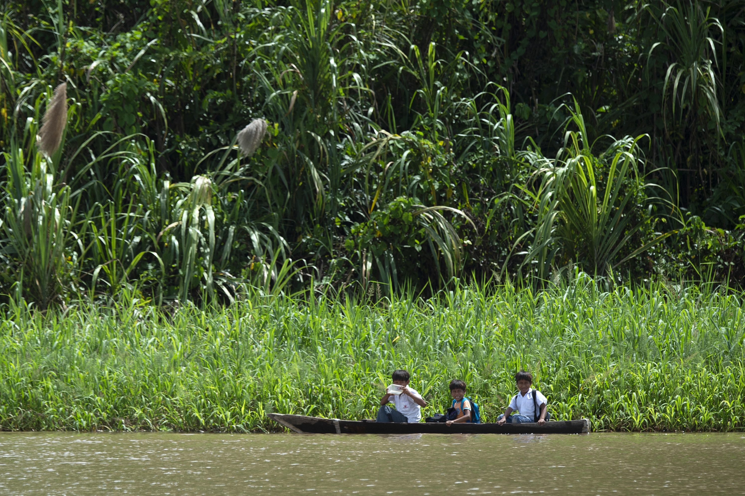 Children go to school by canoe on the Maranon River, a main tributary of the Amazon River, in the Pacaya Samiria National Reserve in May 2019. (Cris Bouroncle/AFP/Getty Images)