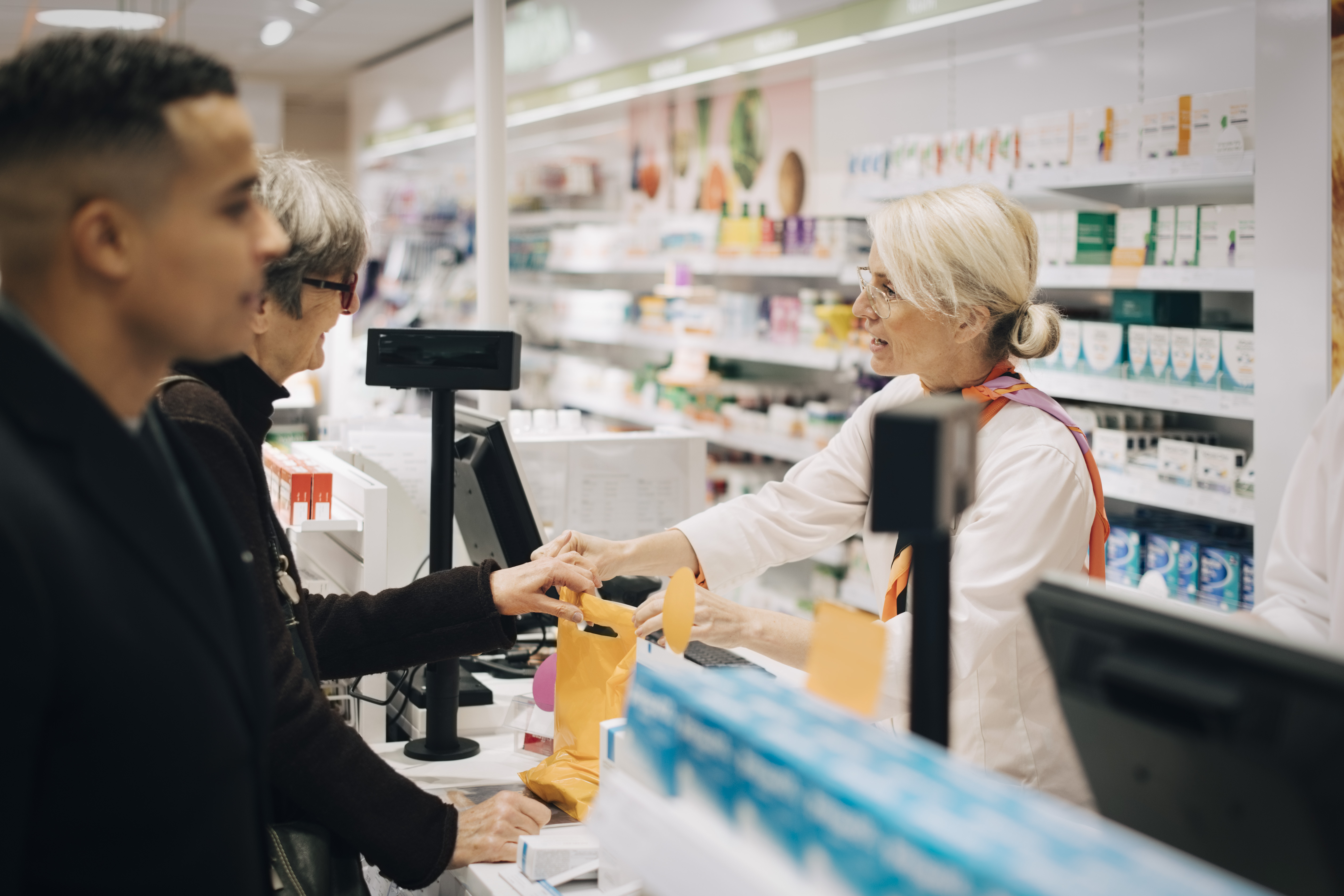 Pharmacists and customers. (Getty Images)