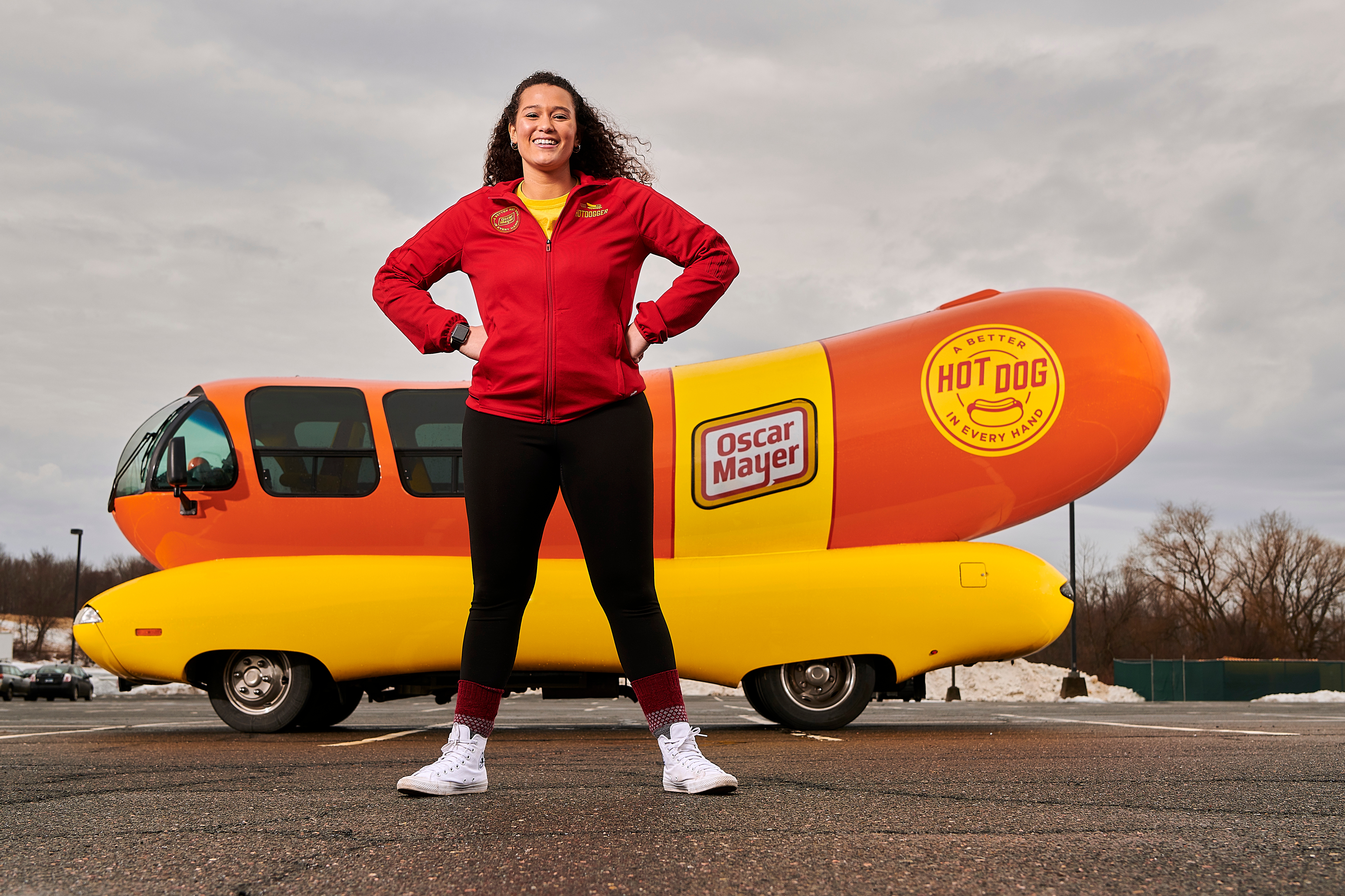Gabriella Medvik '17 (SFA) poses with the Oscar Mayer Wienermobile in campus. (Peter Morenus/UConn Photo)