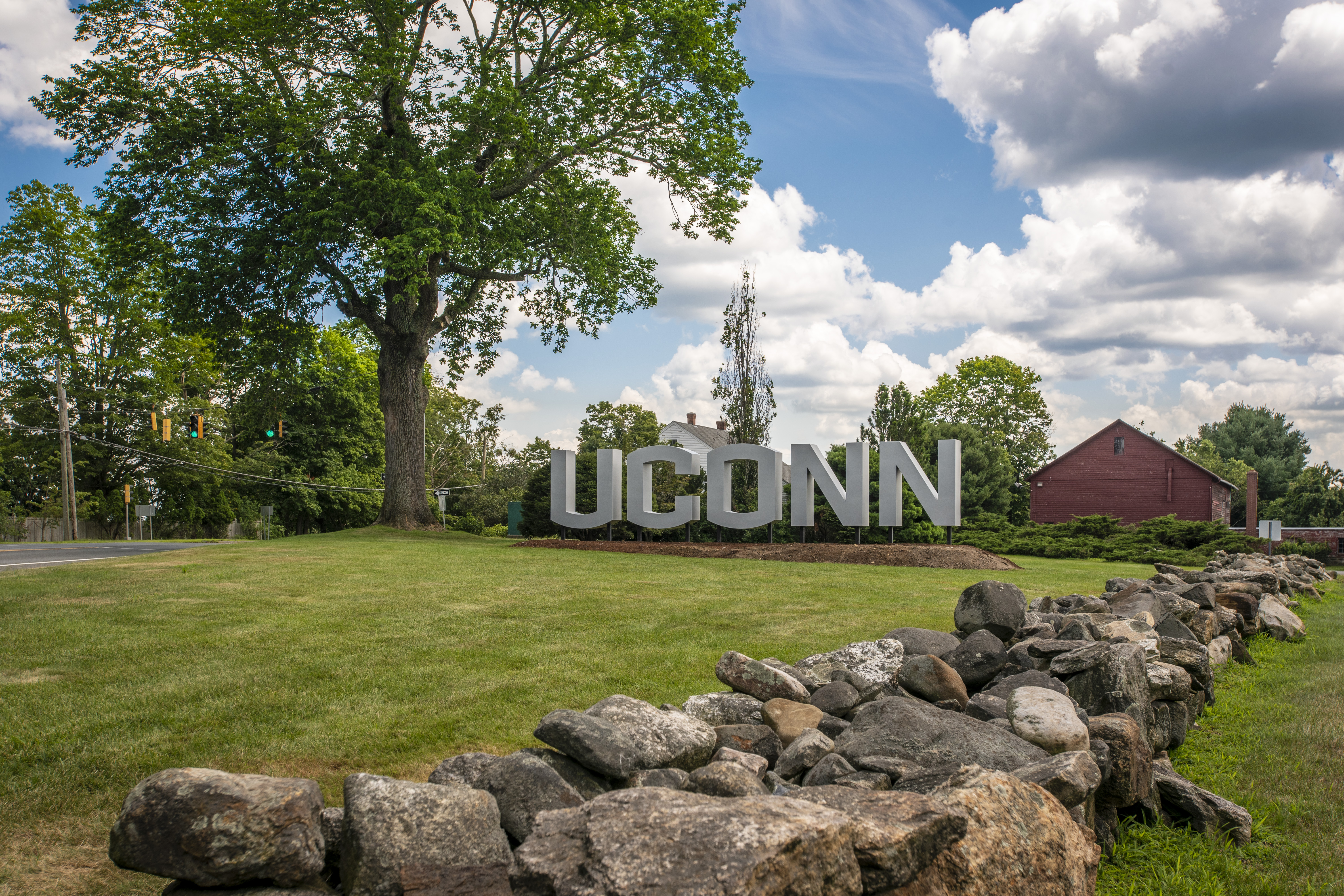 Large letter entrance UConn sign on route 195. July 24, 2019. (Sean Flynn/UConn Photo)