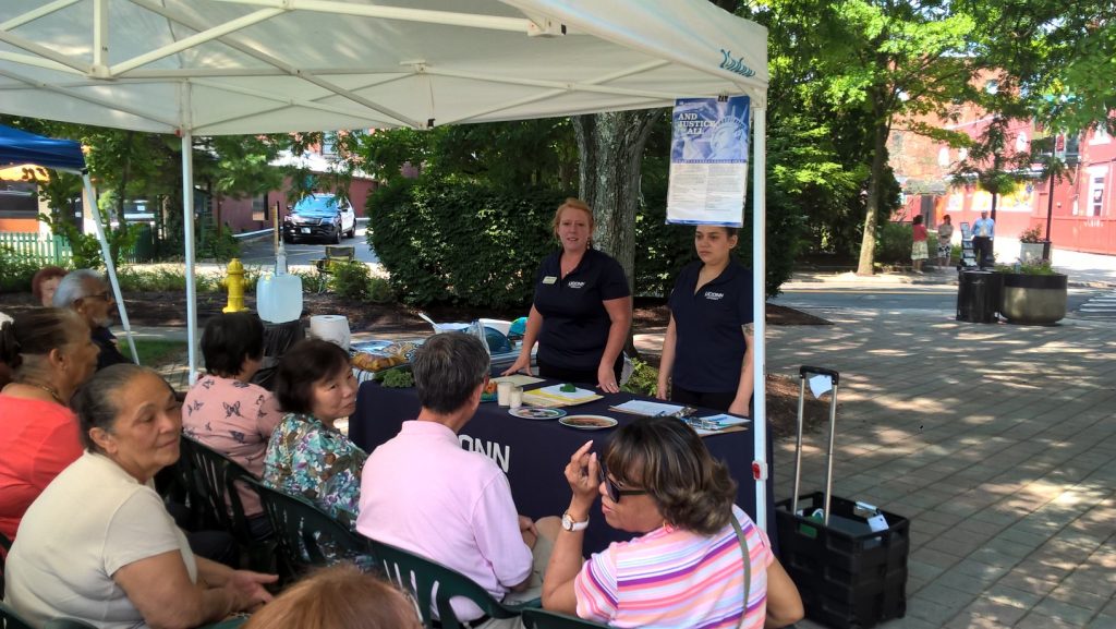 UConn Extension members Heather Peracchio, left, and Julianne Restrepo Marin give a nutrition class in English and Spanish at the Danbury Farmers’ Market. (Sara Putnam/UConn Photo)