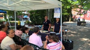 UConn Extension members Heather Peracchio, left, and Julianne Restrepo Marin give a nutrition class in English and Spanish at the Danbury Farmers’ Market. (Sara Putnam/UConn Photo)
