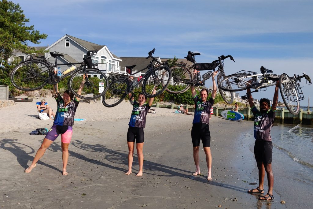 UConn medical students Keanna Chang, Liz Rodier, Justin Hoffman and Yoga Kammili hoist their bicycles on the beach in Old Saybrook