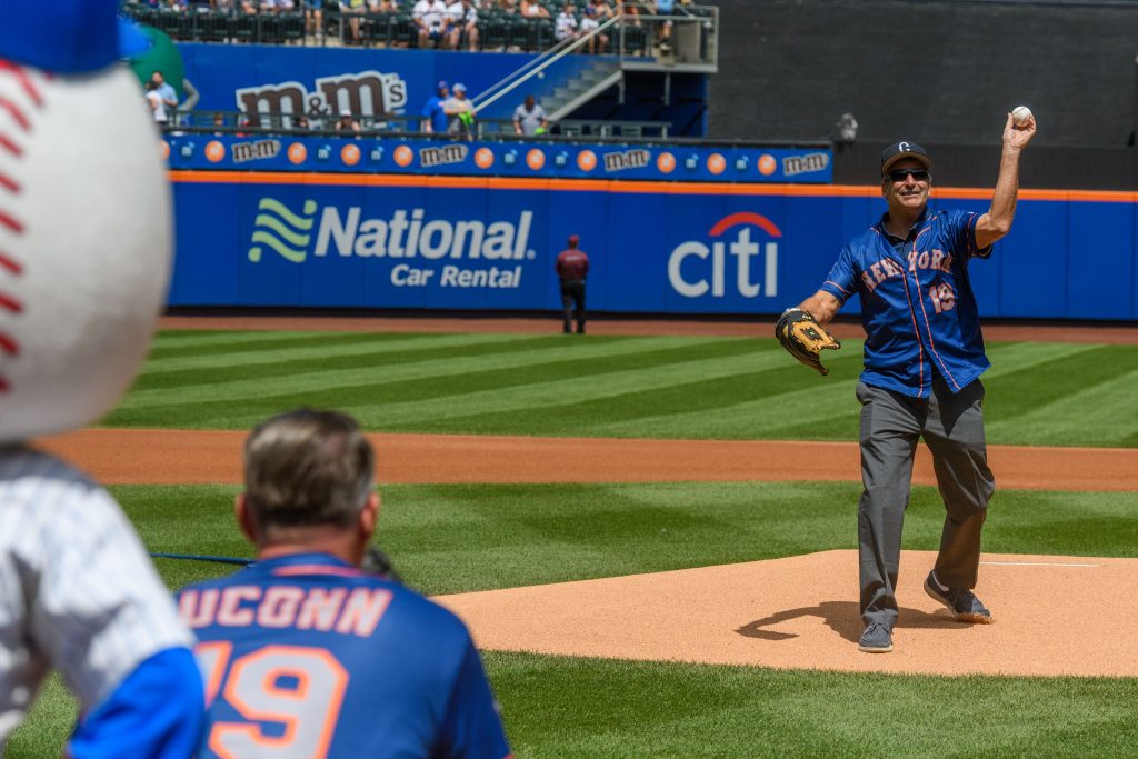 President Tom Katsouleas, right, throws the ceremonial first pitch to Scott Roberts, UConn foundation president, at Citi Field in Queens during a New York Mets baseball game on Aug. 11, 2019. (Peter Morenus/UConn Photo)