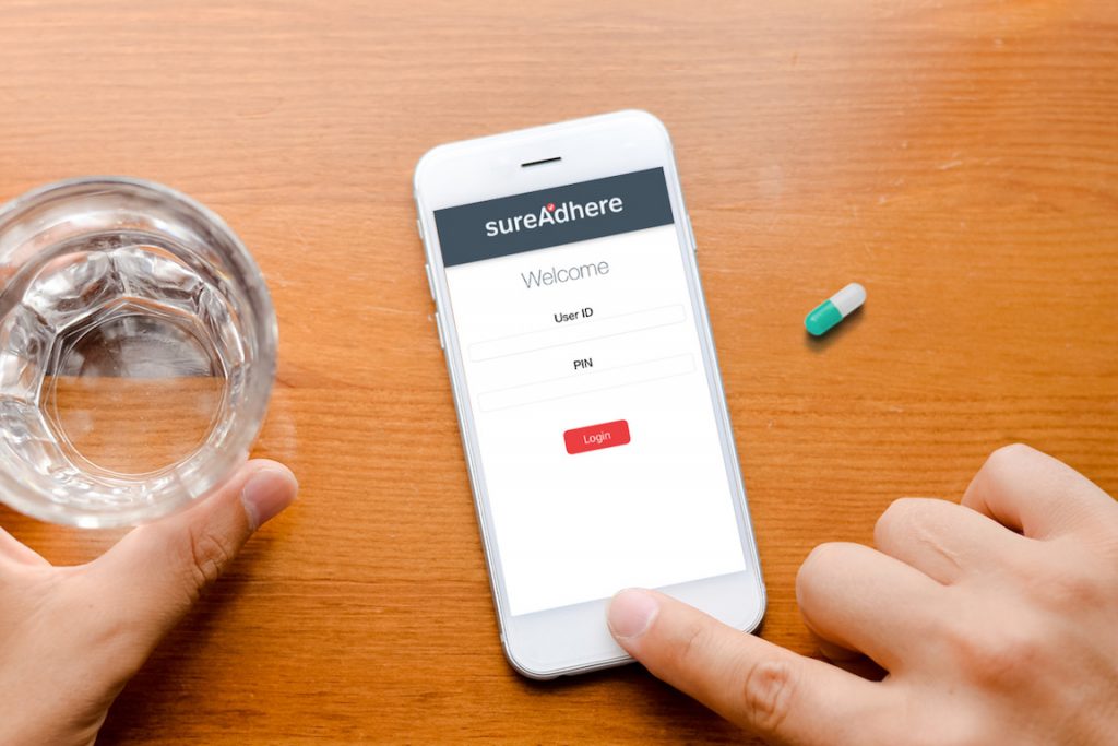 Vendor image of VDOT app, pill, and glass of water