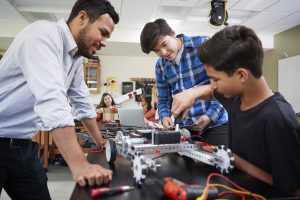Teacher with male students. (Getty Images)