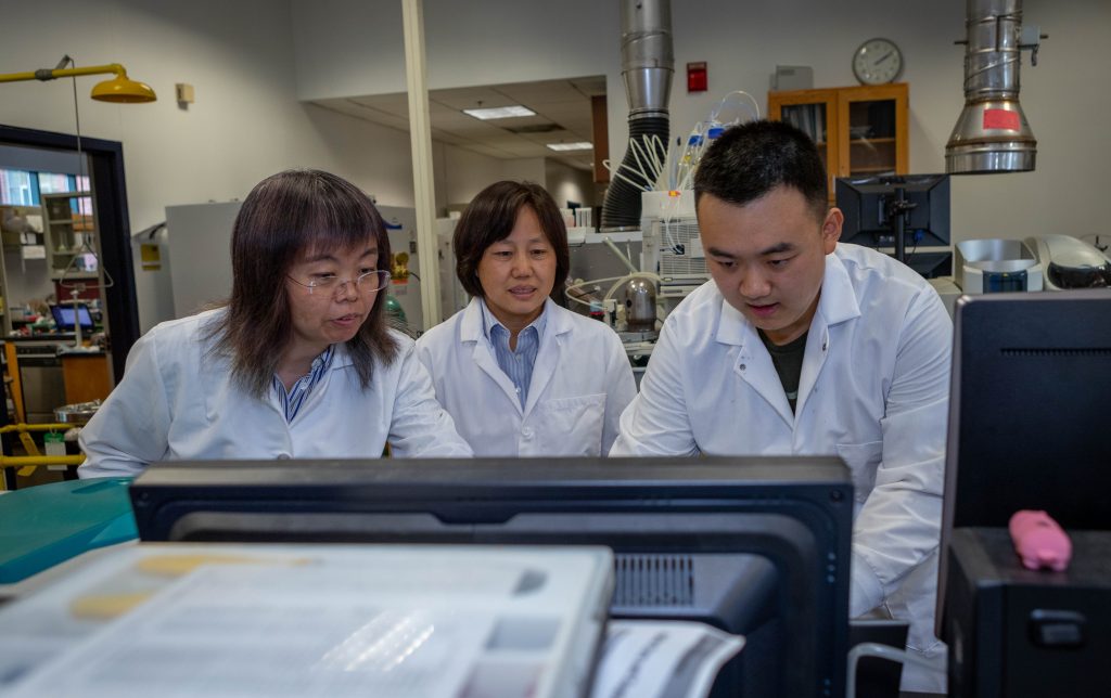 Left to right, UConn Professors Baikun Li, and Guiling Wang, and Wangchi Zhou, Ph.D.