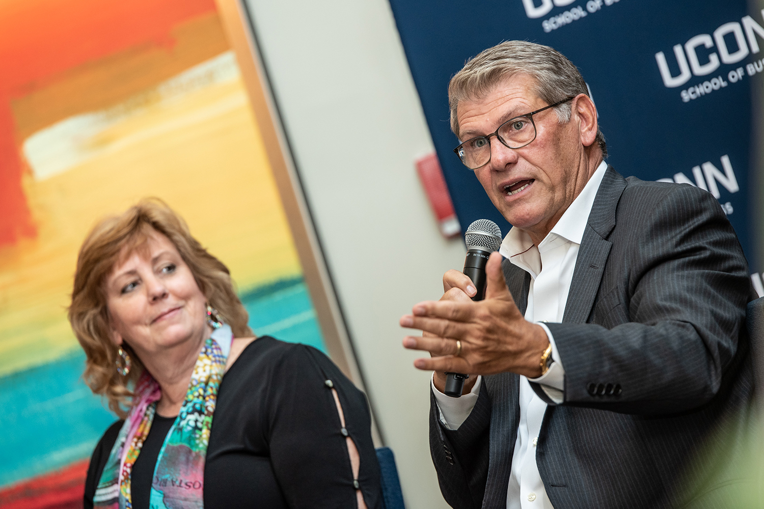 Lucy Gilson (left), Associate Dean of the UConn School of Business and Geno Auriemma (right), Head Coach of UConn Women's Basketball, speak during the first day of the Leadership Conference. This year's program focused on leading through complexity and uncertainty. (Nathan Oldham / UConn School of Business)