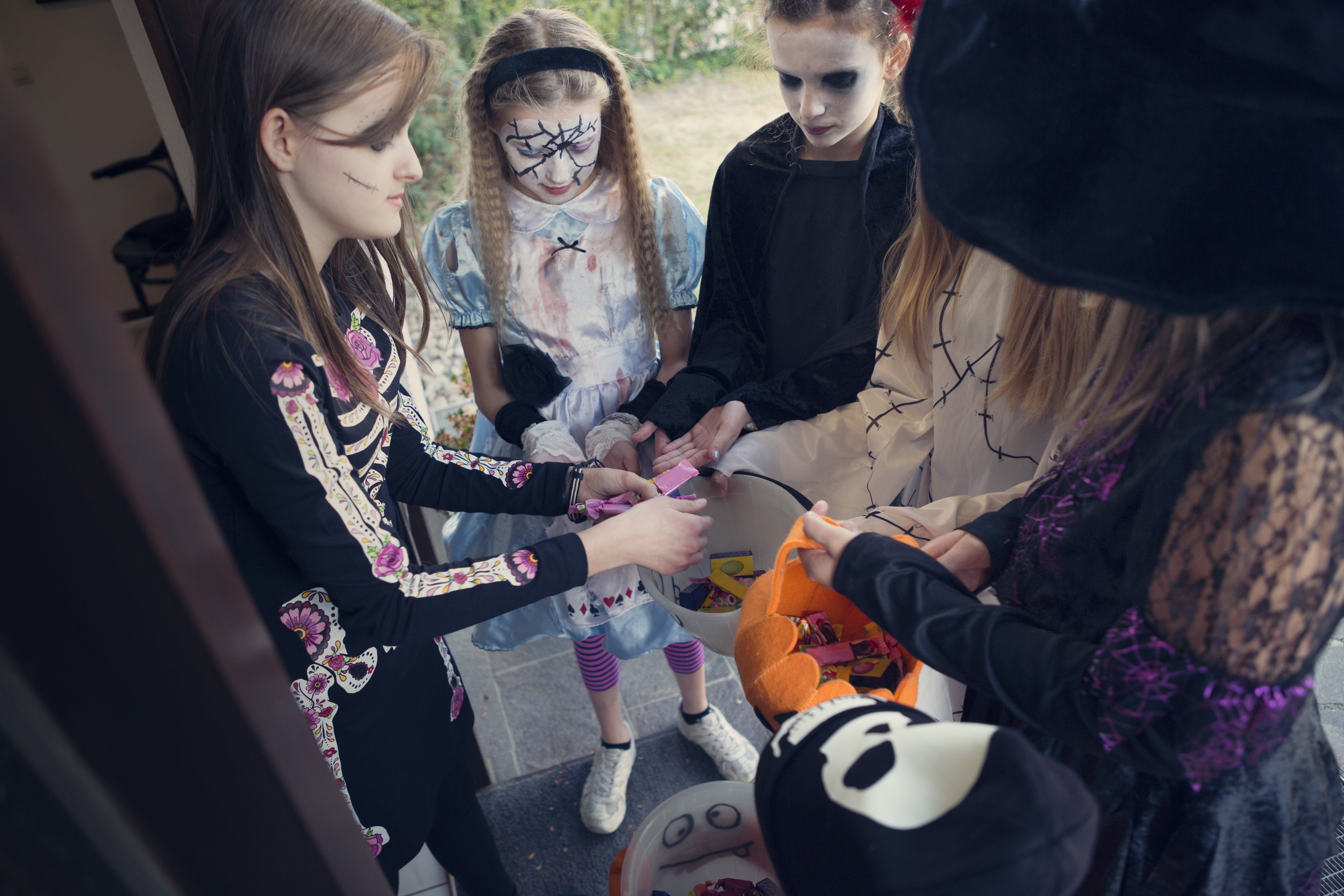 Group of girls trick or treating on Halloween