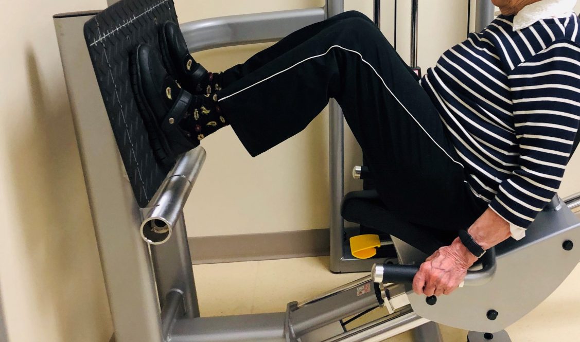 Patient does leg presses at UConn Center on Aging. (Lauren Woods/UConn Photo)