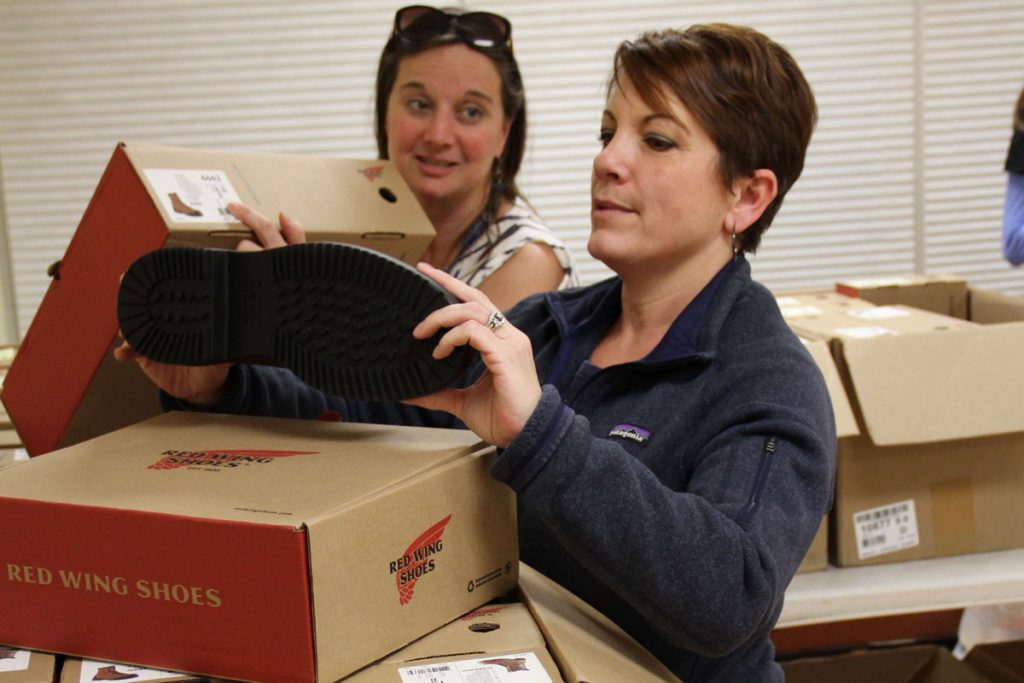 Carmen and Lori going through boxes of shoes