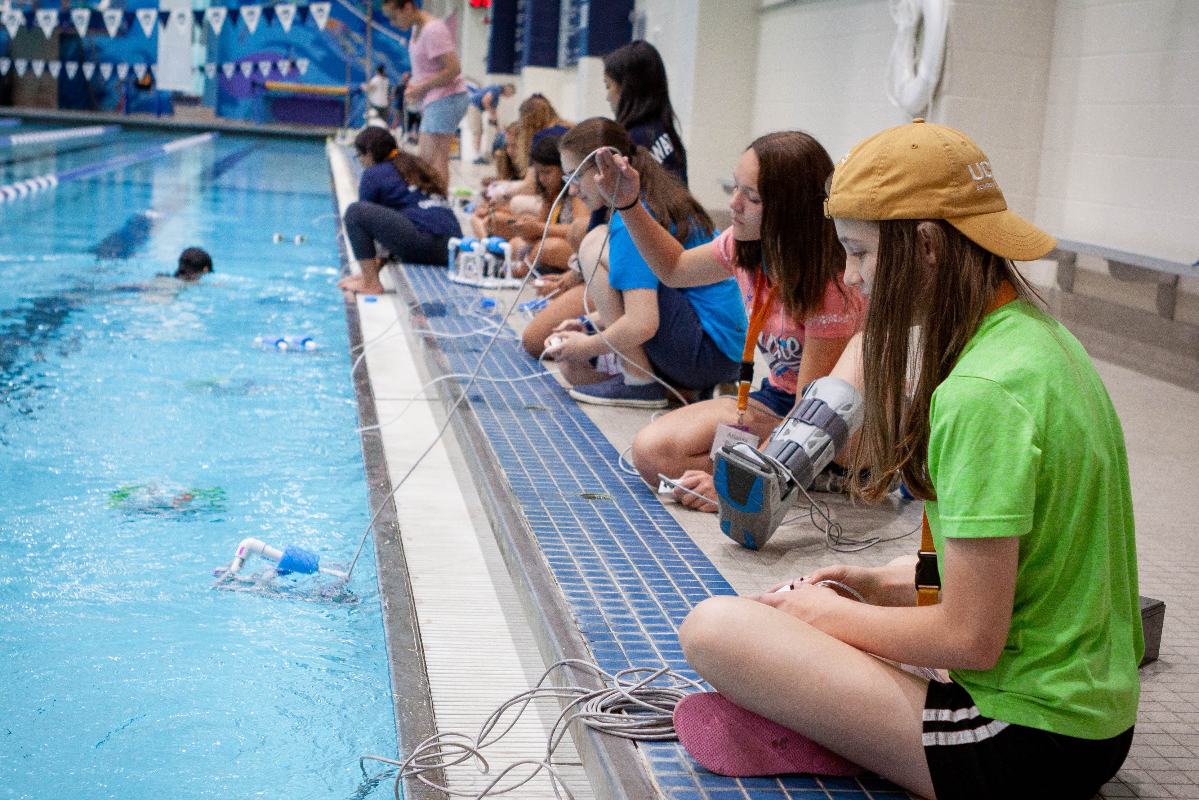 A group of SPARK campers work on their underwater robots in the UConn Wolff-Zackin Natatorium during the summer of 2019. SPARK seeks to mentor and encourage 7th-9th grade females to enter the STEM fields through overnight summer camps. (UConn Photo/Christopher LaRosa)