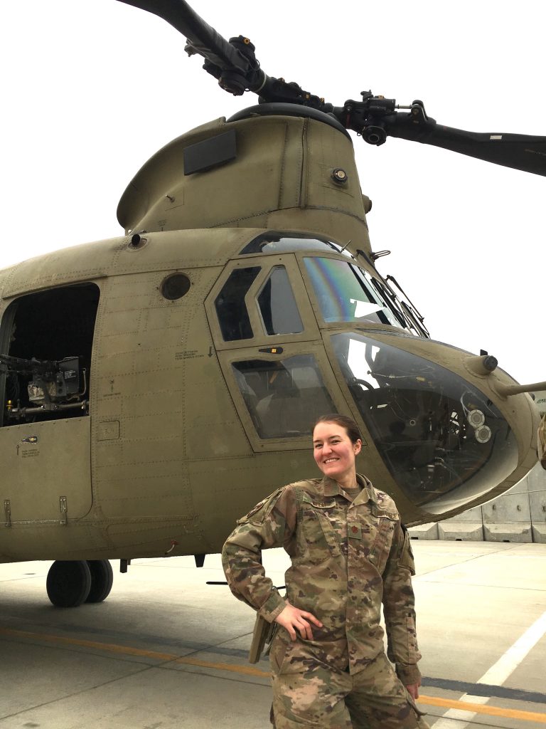 Sarah Kelly in front of a helicopter