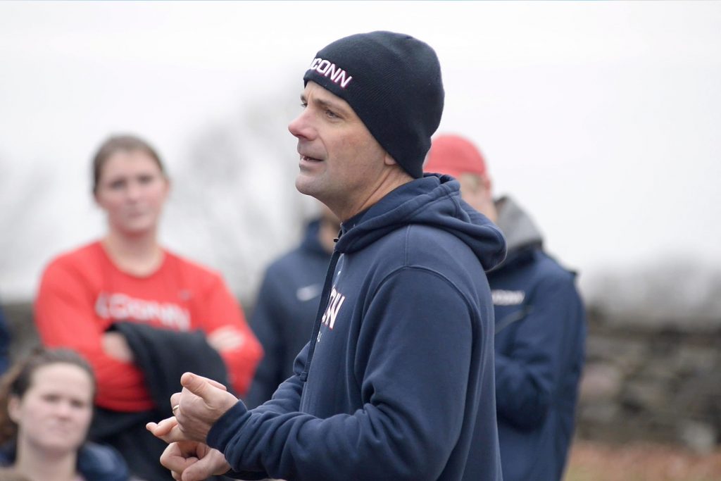 Baseball Coach Jim Penders addressing a group of students at New Storrs Cemetery after a run to the grave of the Storrs Brothers.