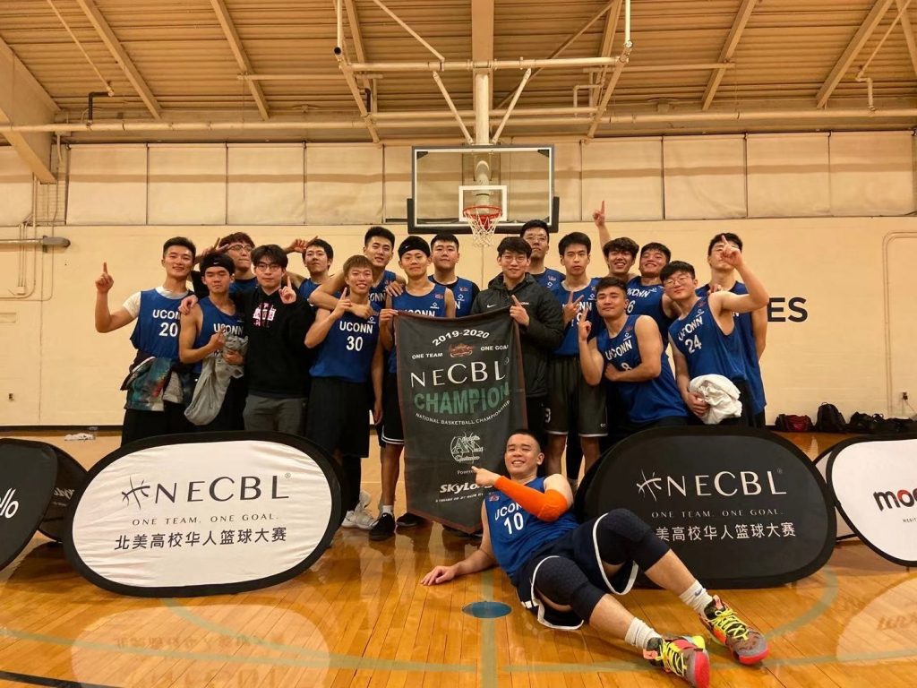 Members of the UConn Chinese Students and Scholars Association basketball team pose on a basketball court